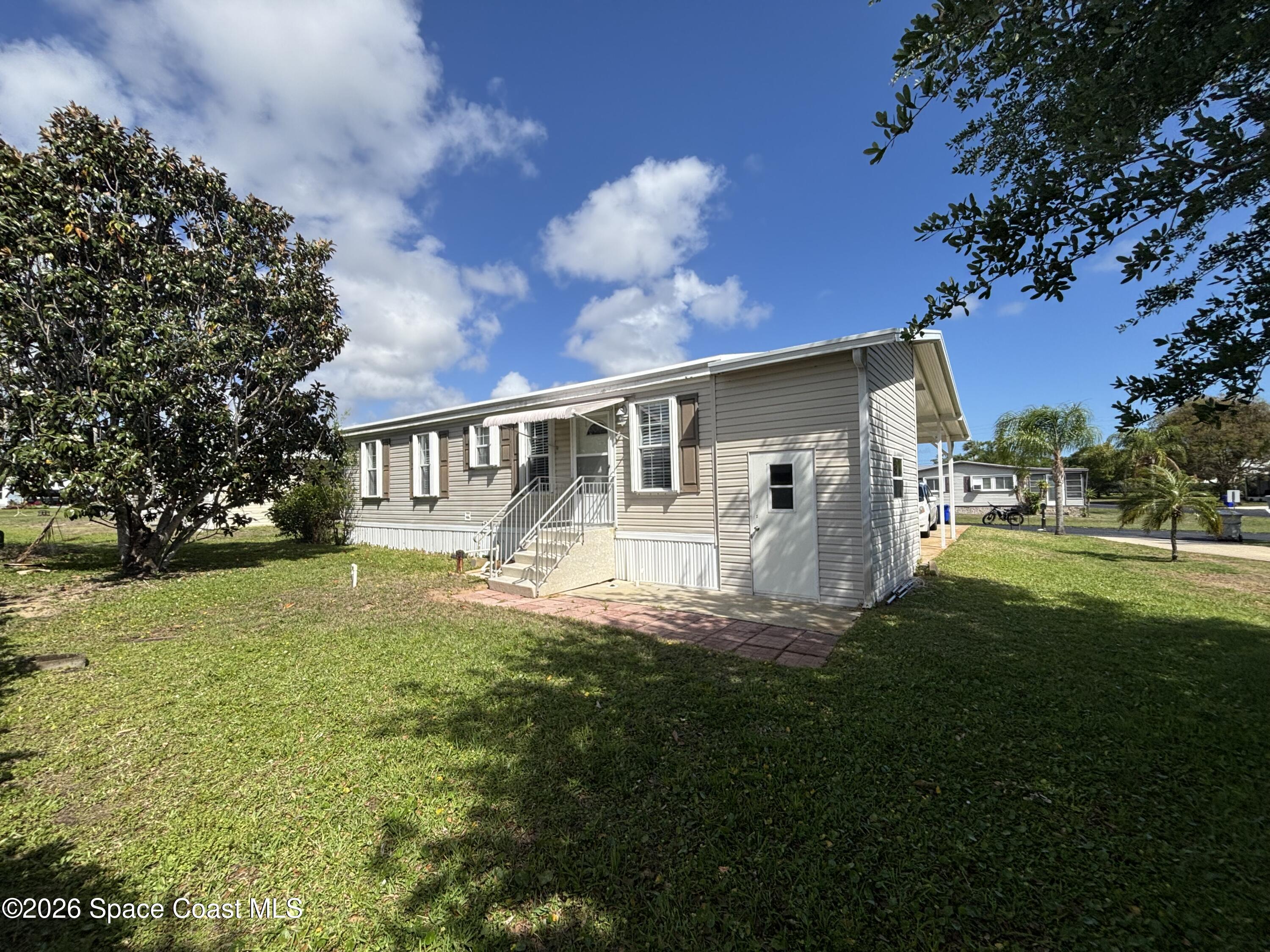 6165 98th Road Sebastian, FL 32958 - Photo 5 of 23 a view of a house with a big yard
