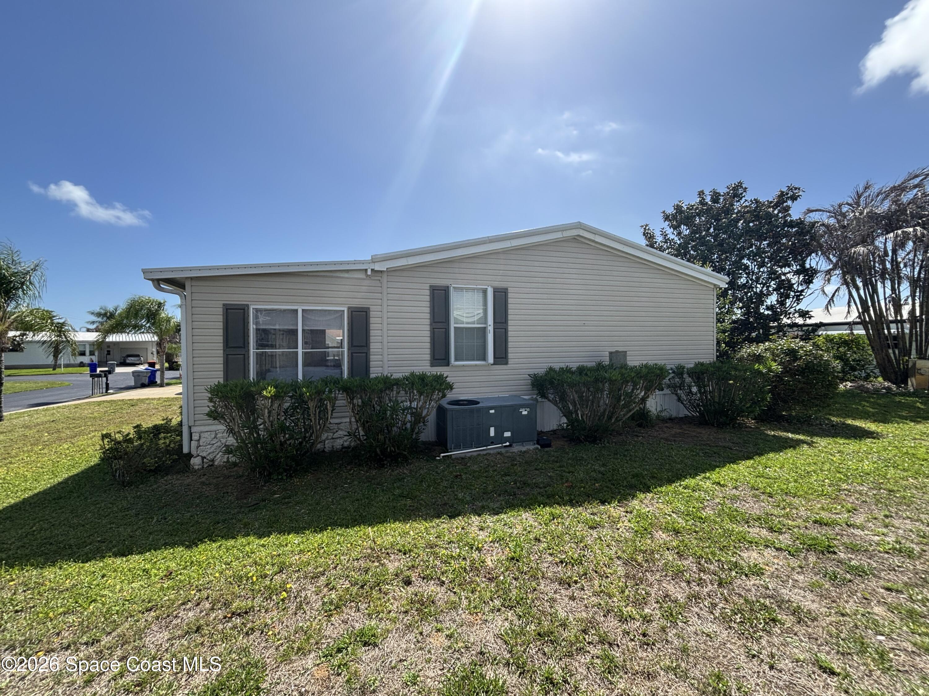 6165 98th Road Sebastian, FL 32958 - Photo 6 of 23 a front view of a house with garden