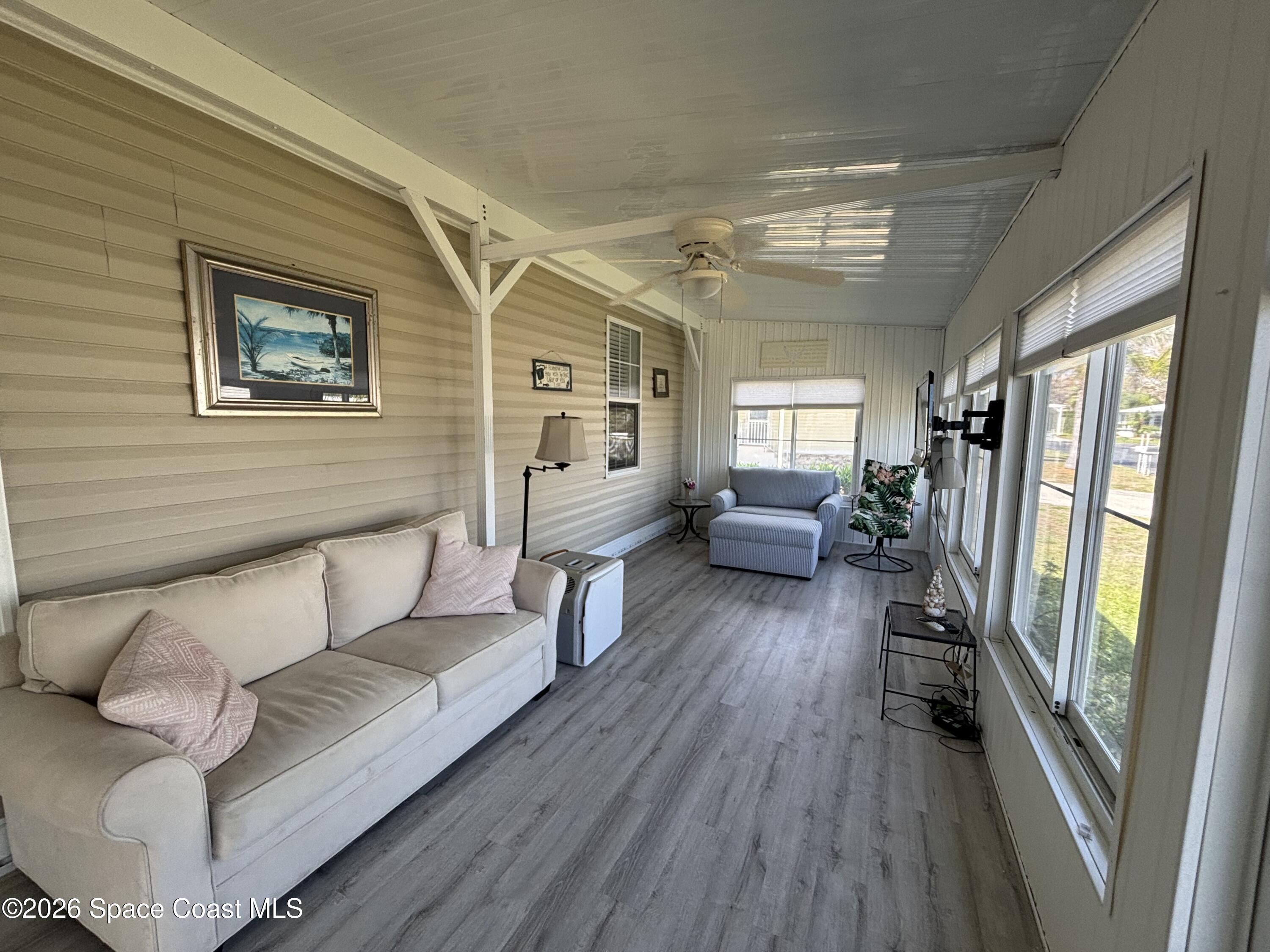 6165 98th Road Sebastian, FL 32958 - Photo 9 of 23 a living room with furniture and a wooden floor