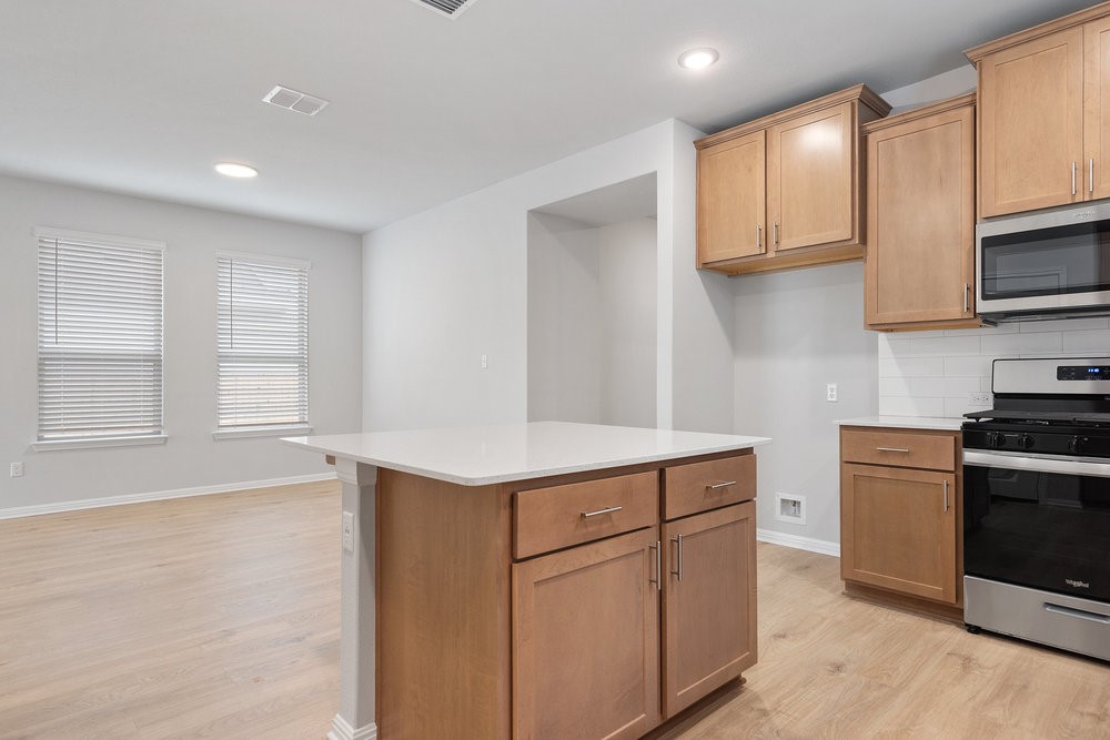132 Condesa Street Kyle, TX 78640 - Photo 12 of 26 a kitchen with stainless steel appliances granite countertop a sink and a stove