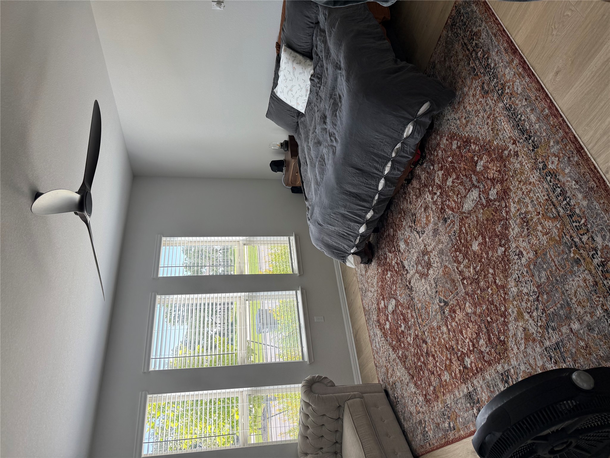 132 Condesa Street Kyle, TX 78640 - Photo 15 of 26 a bedroom with a bed and glass windows