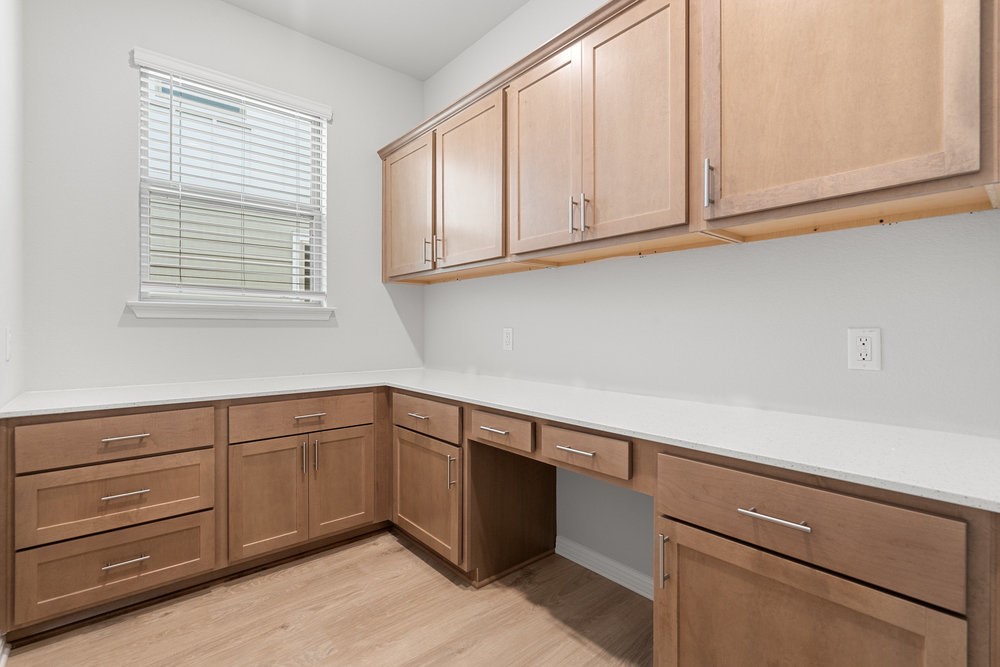 132 Condesa Street Kyle, TX 78640 - Photo 23 of 26 a kitchen with cabinets and window