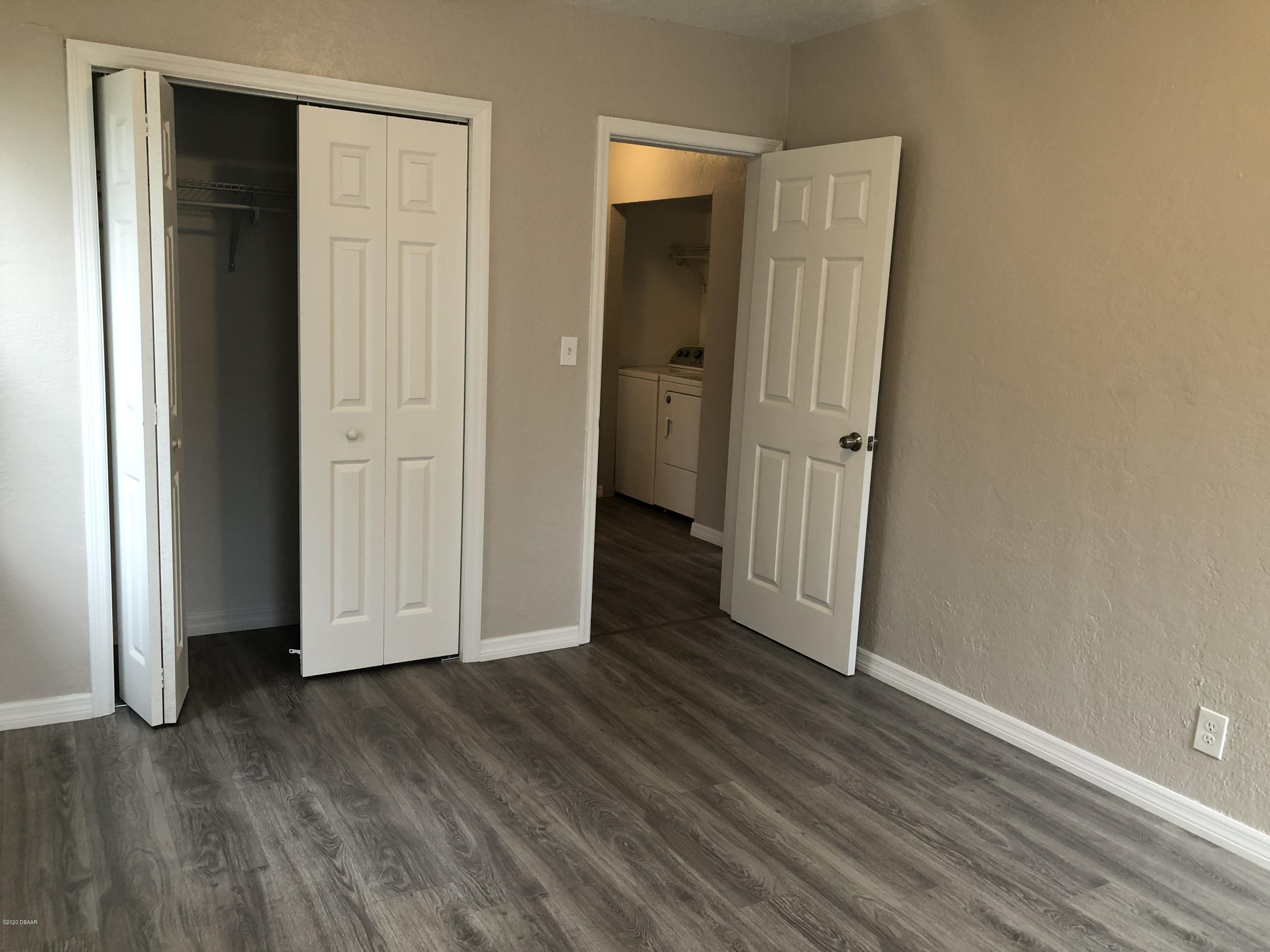 294 Roosevelt Drive Ormond Beach, FL 32174 - Photo 14 of 18 an empty room with wooden floor and closet area