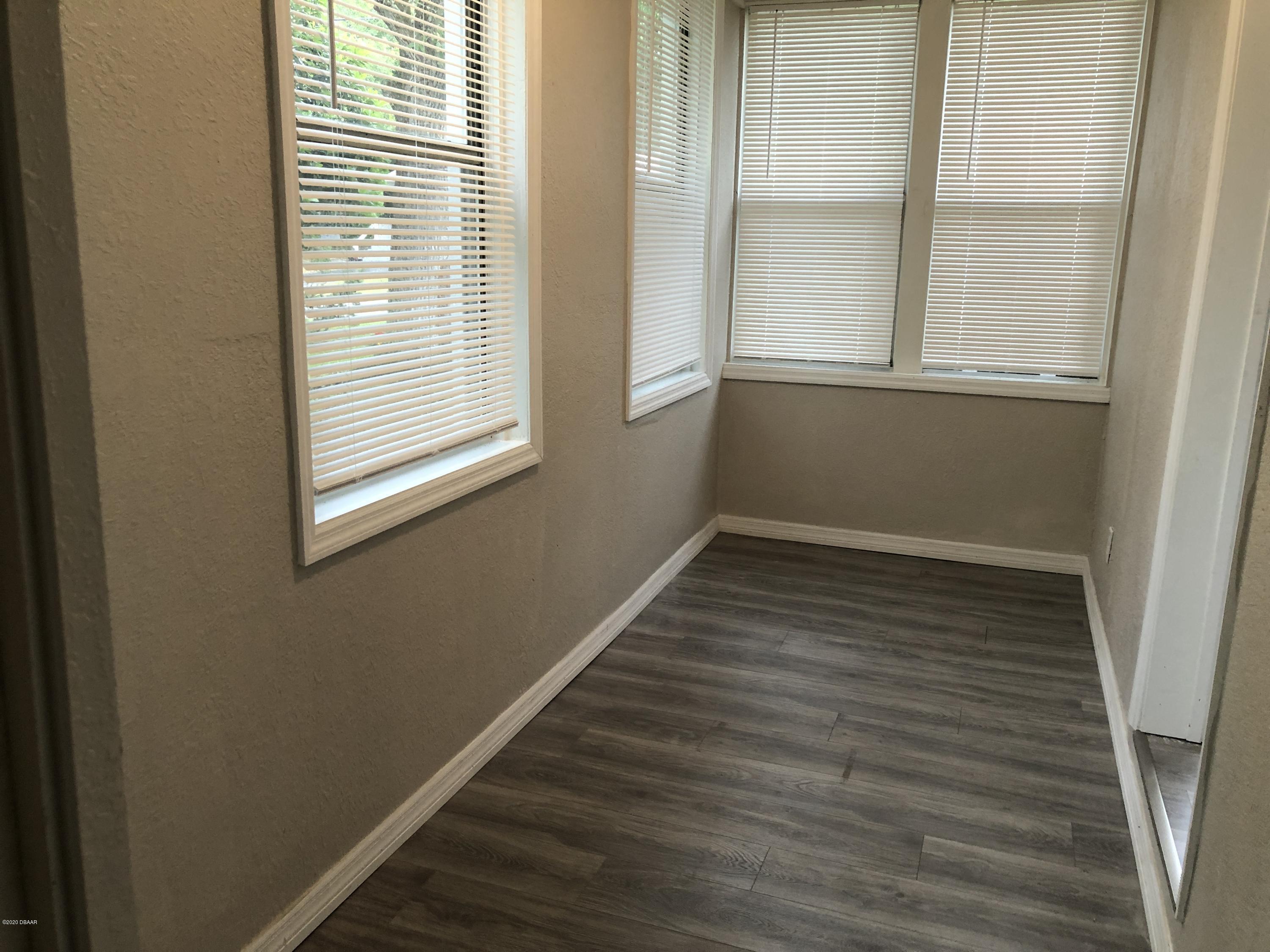 294 Roosevelt Drive Ormond Beach, FL 32174 - Photo 15 of 18 a view of a room with wooden floor and a window