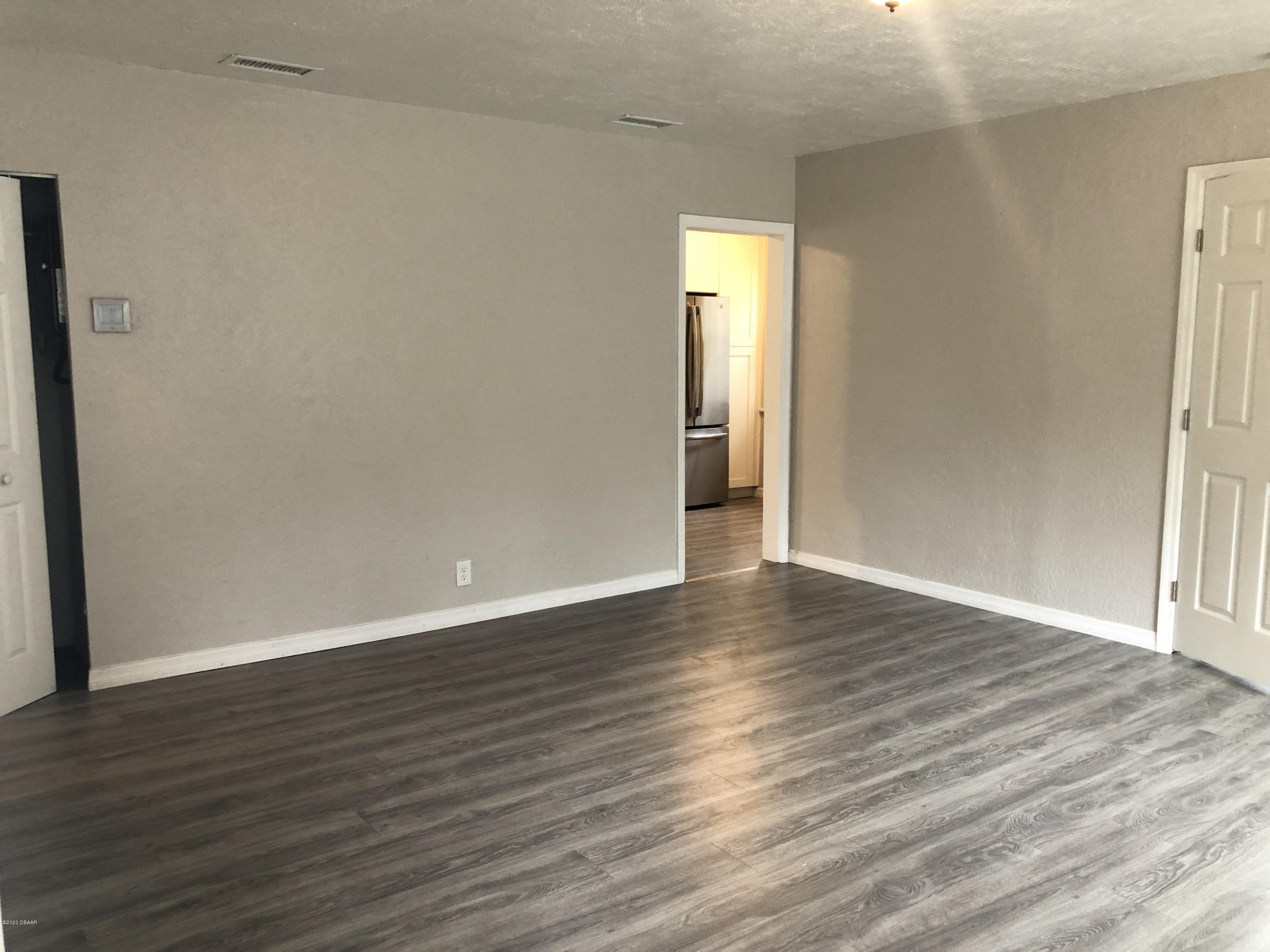 294 Roosevelt Drive Ormond Beach, FL 32174 - Photo 3 of 18 a view of empty room with wooden floor and fan