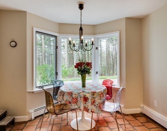 79 Ledge Rock Road Concord, MA 01742 - Photo 7 of 28 a dining room with chandelier and wooden floor