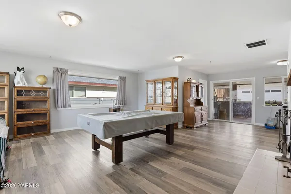 a bedroom with a bed and a flat tv screen on dresser