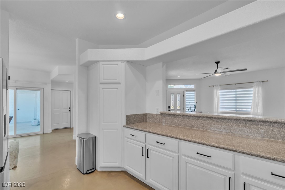 655 Florence Drive Boulder City, NV 89005 - Photo 13 of 63 Kitchen with finished concrete floors, light stone counters, white cabinetry, recessed lighting.