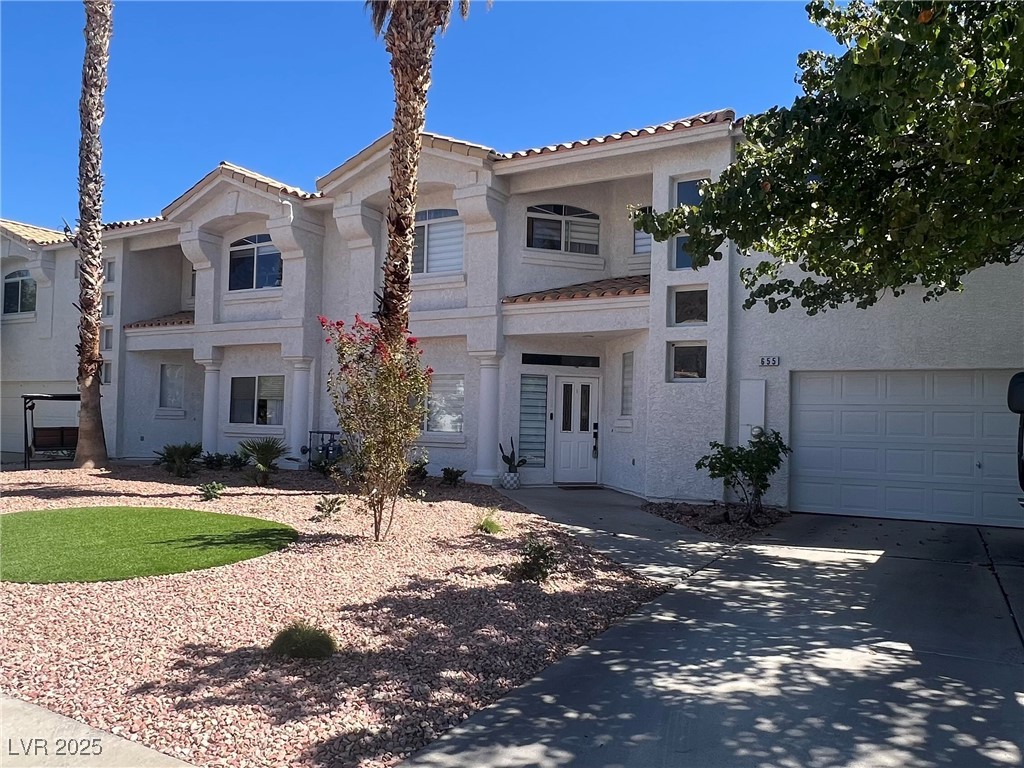 655 Florence Drive Boulder City, NV 89005 - Photo 2 of 63 Mediterranean / spanish-style home featuring stucco siding, a tiled roof, a garage, a balcony, and driveway