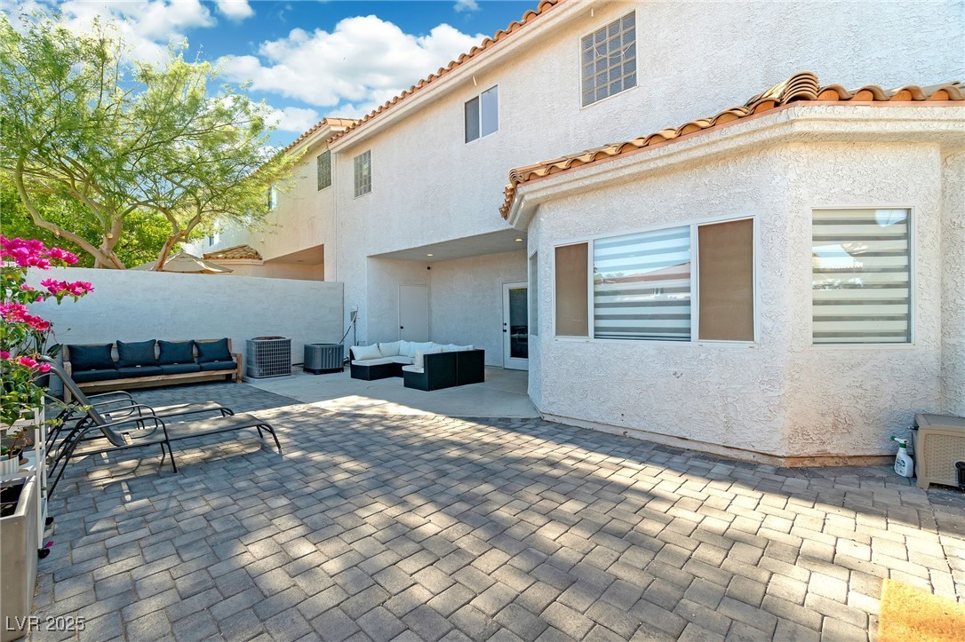 655 Florence Drive Boulder City, NV 89005 - Photo 38 of 63 Rear view of house with a patio, an outdoor living space, a tile roof, and stucco siding