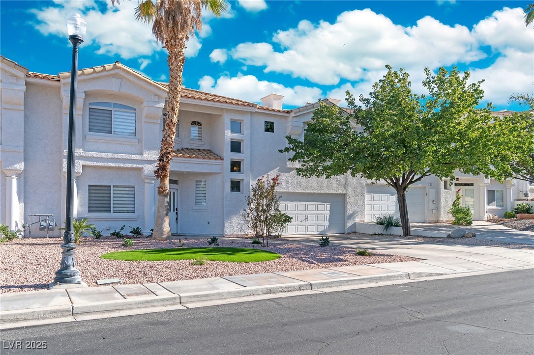 655 Florence Drive Boulder City, NV 89005 - Photo 4 of 63 Mediterranean / spanish house with driveway, stucco siding, a tile roof, and a balcony