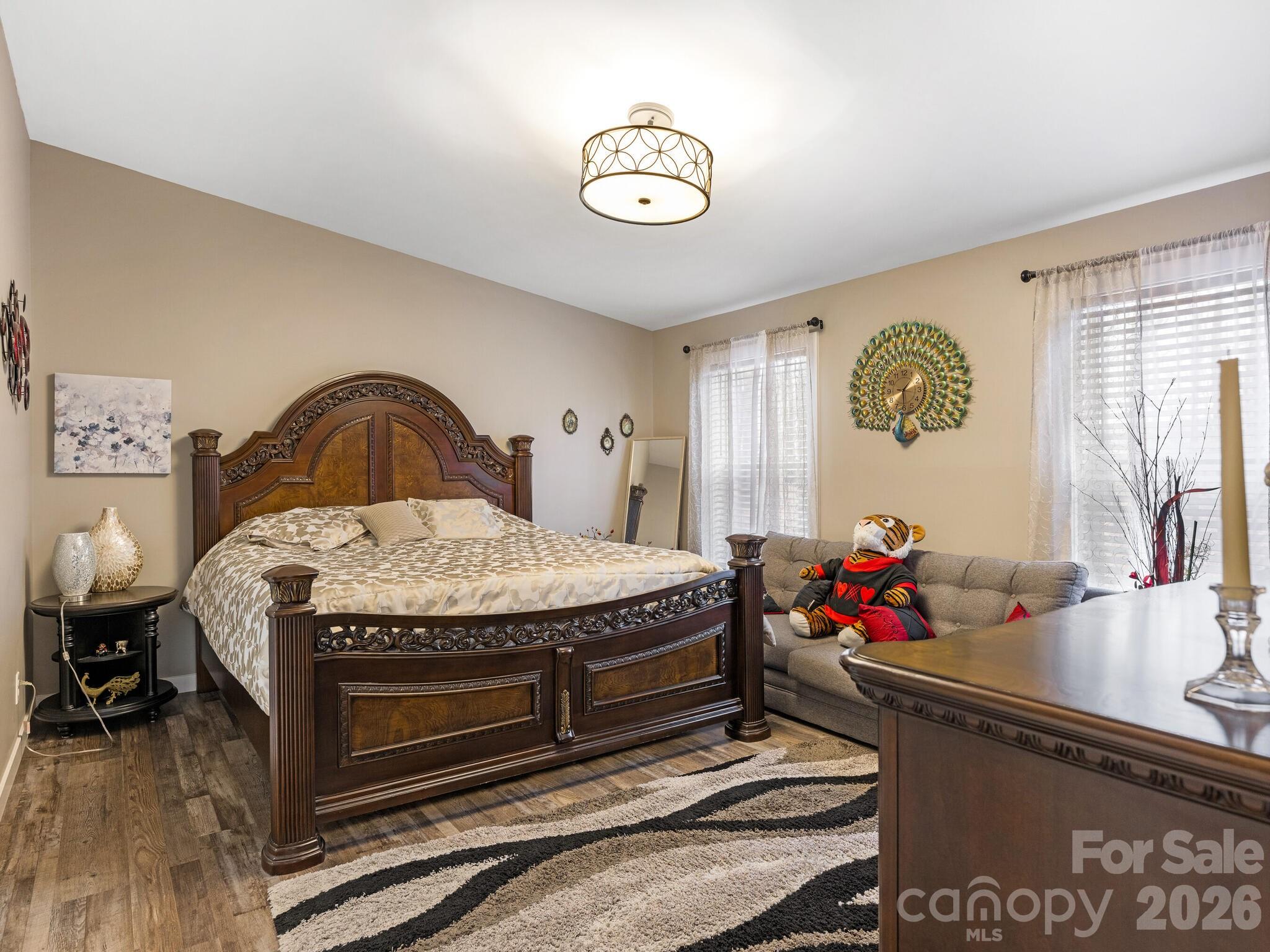 2219 State Rd S-13-106 Pageland, SC 29728 - Photo 11 of 29 a bedroom with a bed and a chandelier