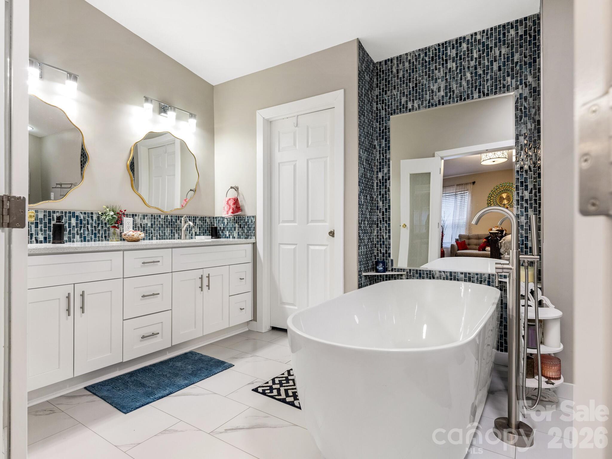 2219 State Rd S-13-106 Pageland, SC 29728 - Photo 13 of 29 a bathroom with a double vanity sink mirror and bathtub