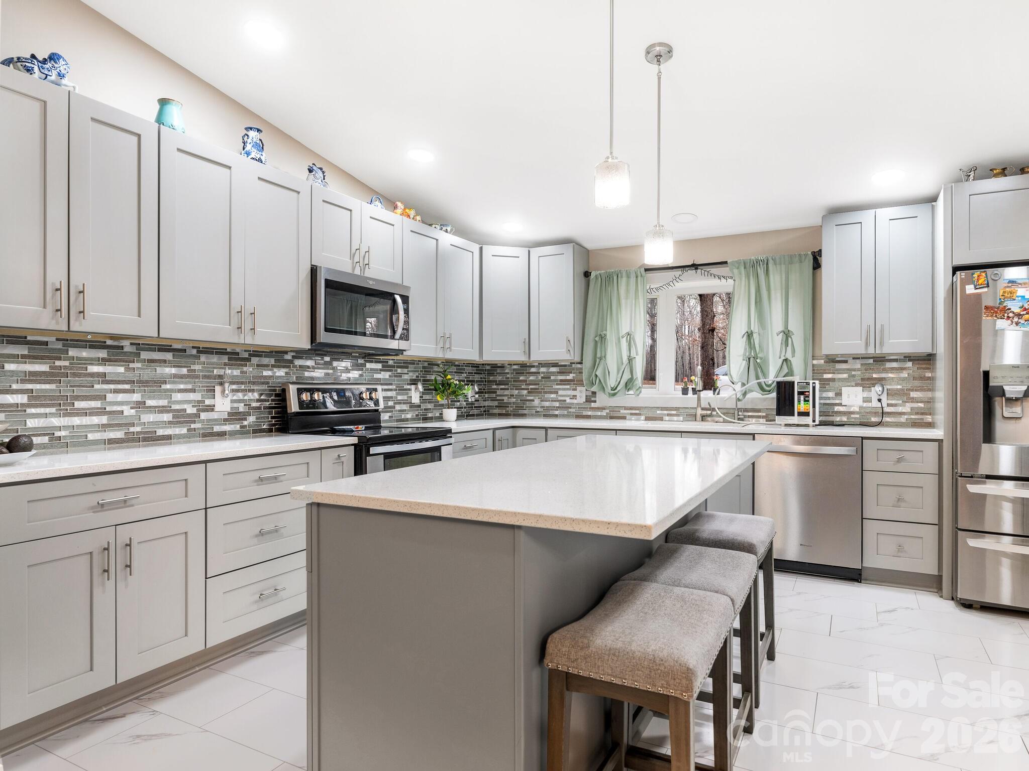 2219 State Rd S-13-106 Pageland, SC 29728 - Photo 2 of 29 a kitchen with stainless steel appliances kitchen island granite countertop a stove a sink a refrigerator and a microwave