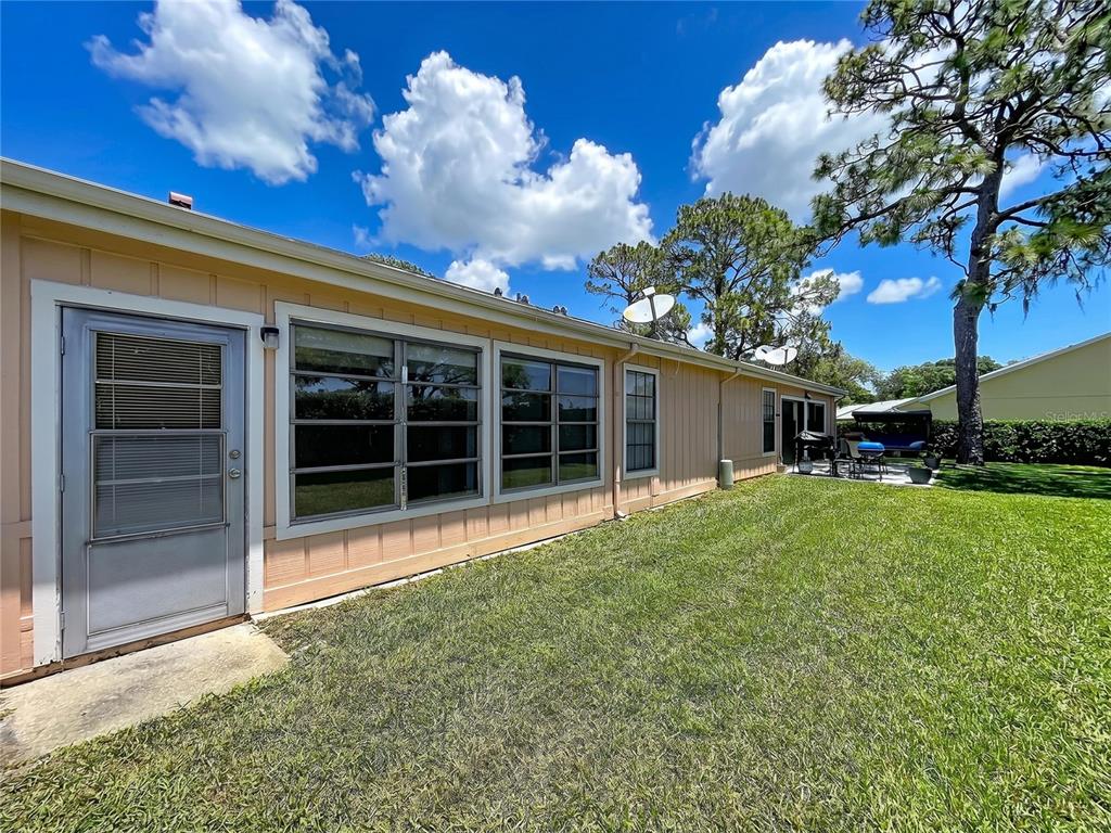 9319 Trowbridge Court New Port Richey, FL 34655 - Photo 4 of 78 a view of a house with backyard and garden