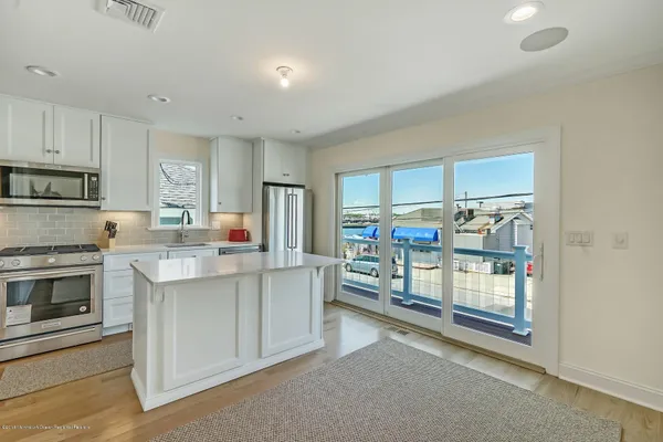 a kitchen that has a lot of cabinets in it and appliances