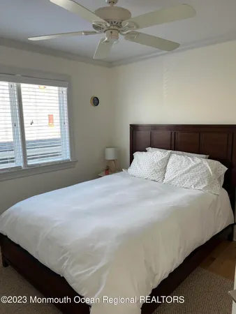 a bedroom with a bed and a night stand