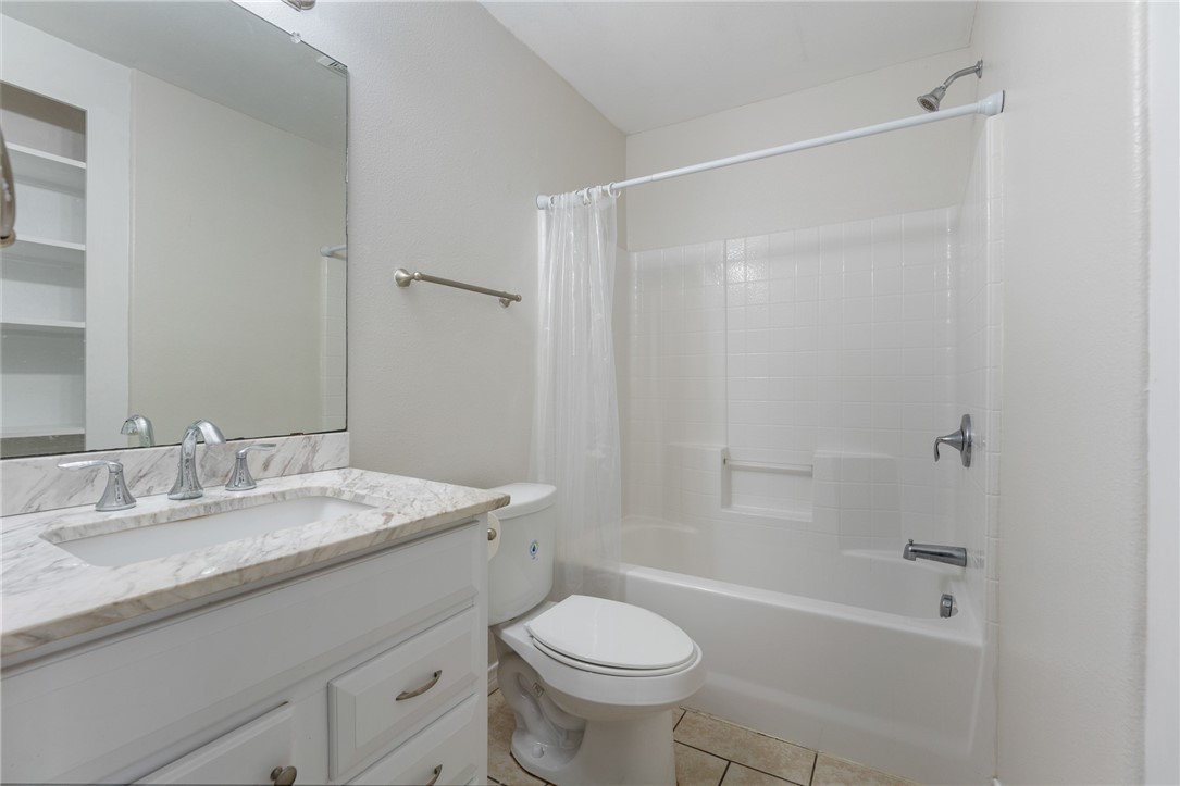 410 Knickerbocker Street Corpus Christi, TX 78418 - Photo 12 of 24 a bathroom with a granite countertop sink toilet and shower