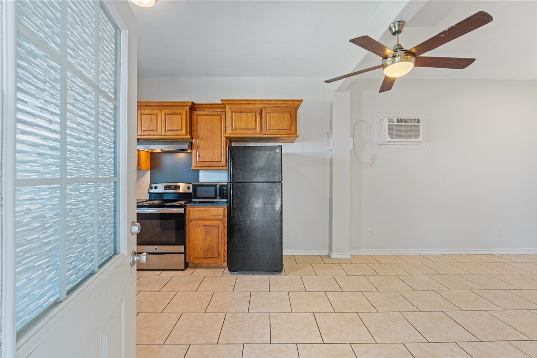 410 Knickerbocker Street Corpus Christi, TX 78418 - Photo 17 of 24 a kitchen with a refrigerator a stove top oven a sink and a window