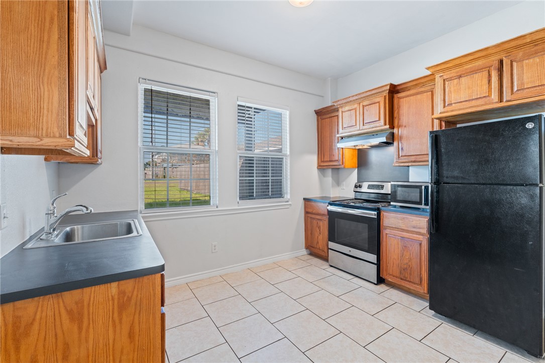 410 Knickerbocker Street Corpus Christi, TX 78418 - Photo 18 of 24 a kitchen with stainless steel appliances granite countertop a refrigerator and a sink