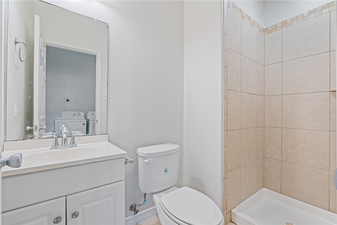 410 Knickerbocker Street Corpus Christi, TX 78418 - Photo 23 of 24 a bathroom with a toilet a sink and mirror