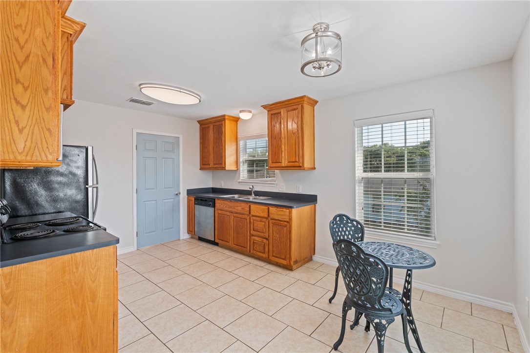 410 Knickerbocker Street Corpus Christi, TX 78418 - Photo 5 of 24 a kitchen with stainless steel appliances granite countertop a stove a sink and a microwave