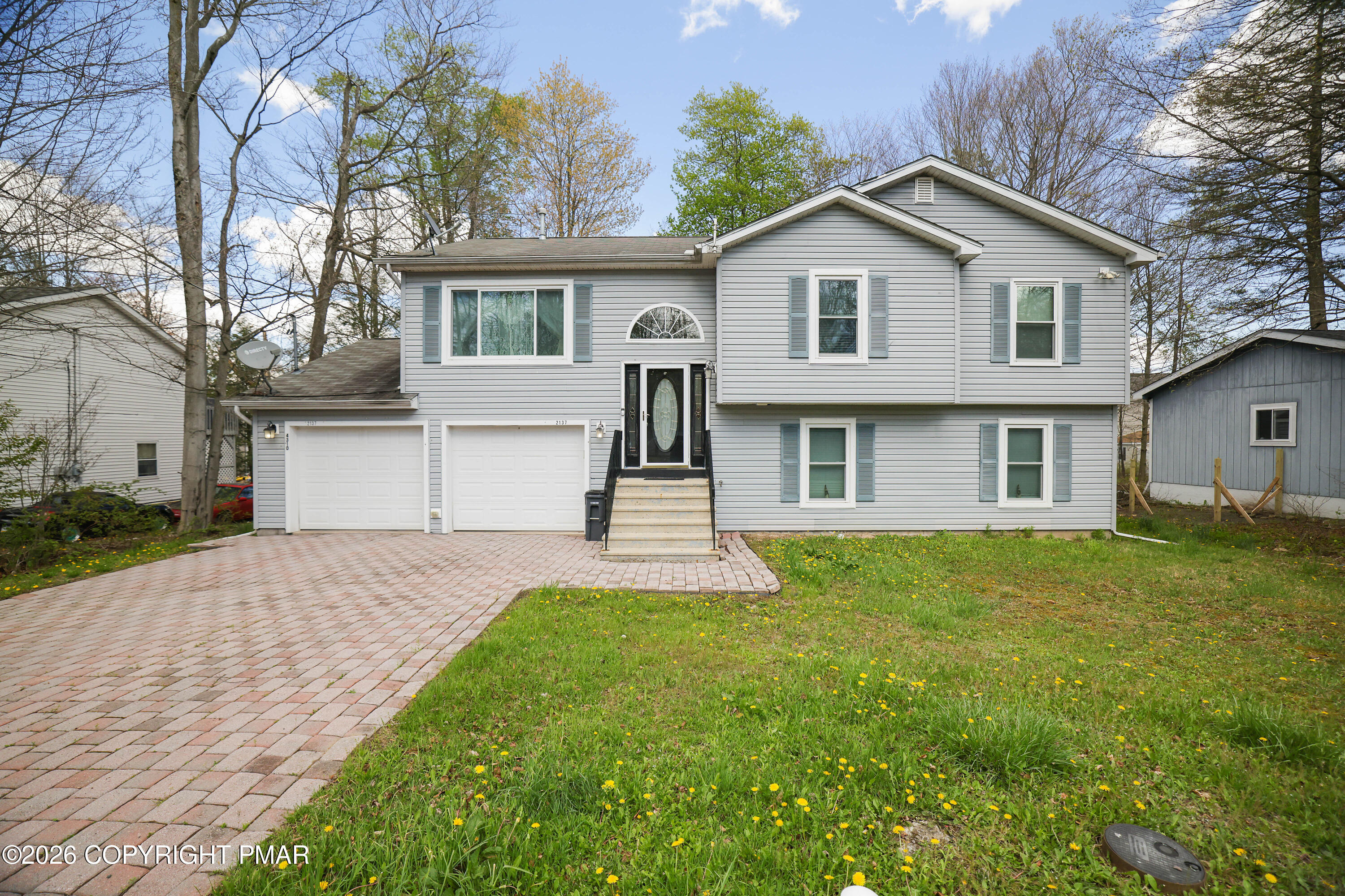 2137 Freedom Way Pocono Summit, PA 18346 - Photo 71 of 71 a front view of a house with a yard and trees