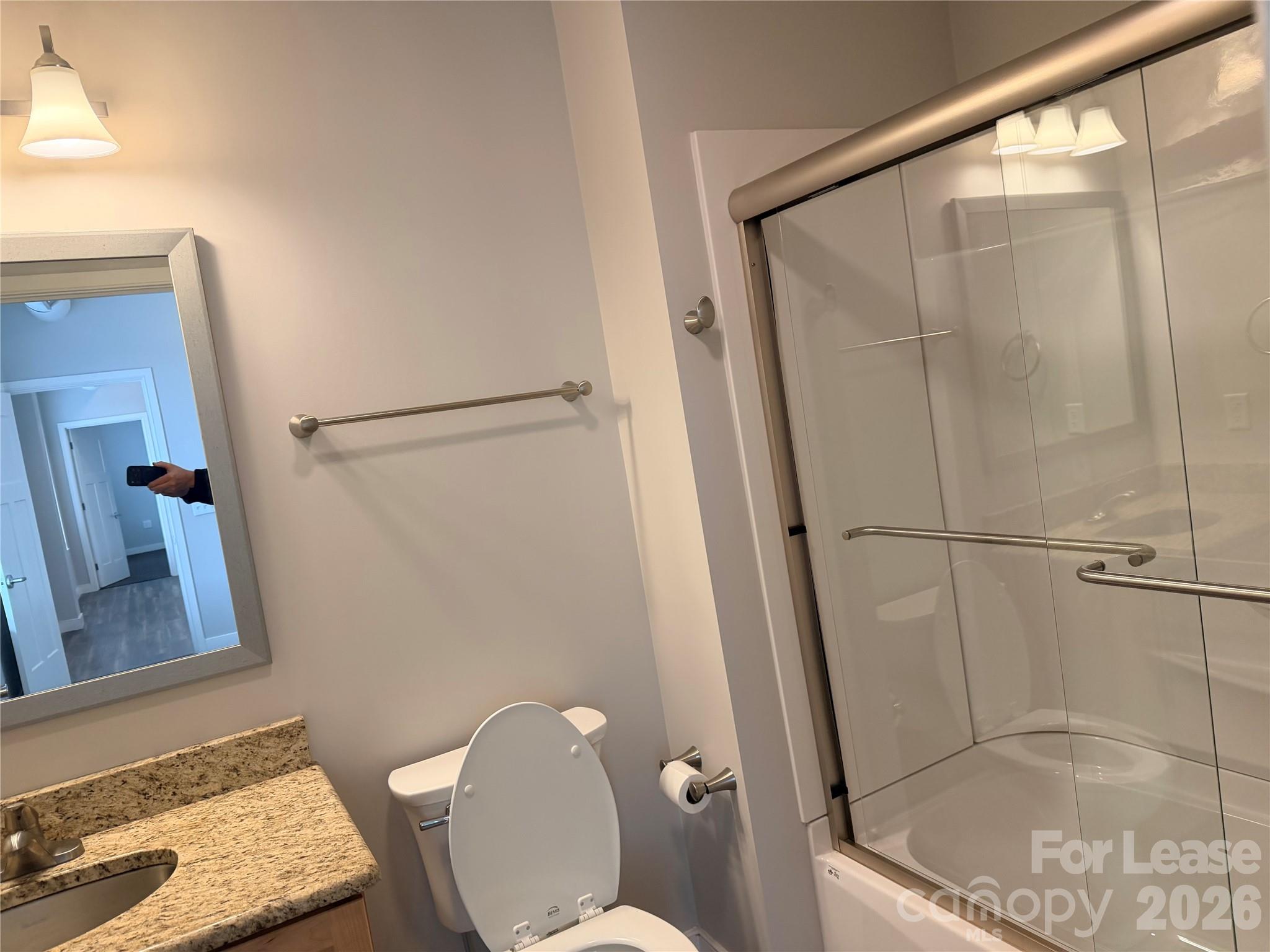 201 East Innes Street, Unit 204 Salisbury, NC 28144 - Photo 21 of 24 a bathroom with a shower a toilet and a sink