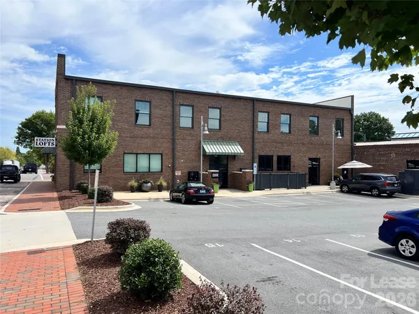 a view of a car parked in front of a brick house