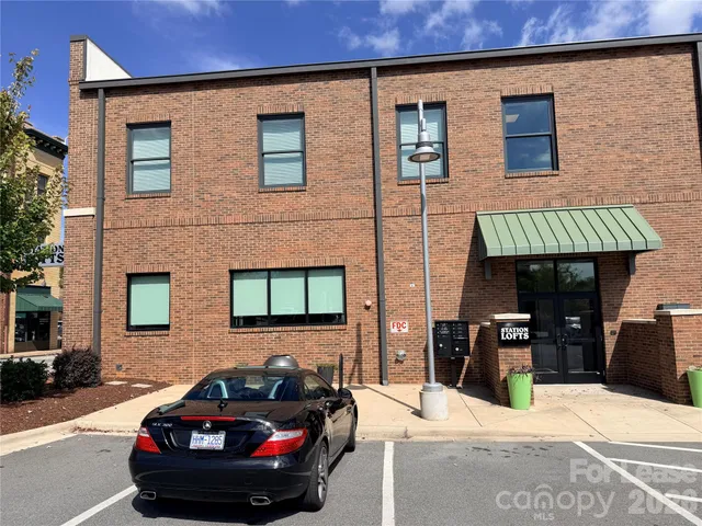 a car parked in front of a brick building