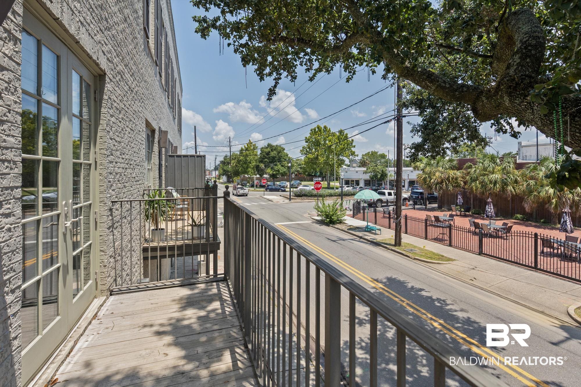 701 Dauphin Street, Unit A Mobile, AL 36602 - Photo 25 of 31 Private balcony with wood-finish flooring and black metal railing