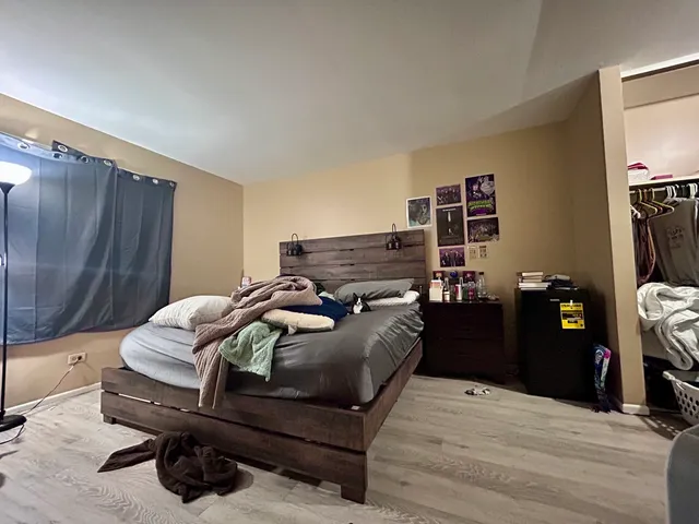 a bedroom with a bed and a television