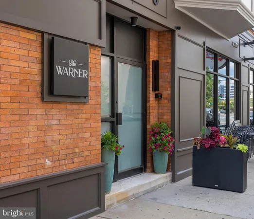 a front view of a house with potted plants