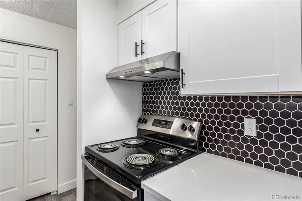 a kitchen with a stove and a microwave