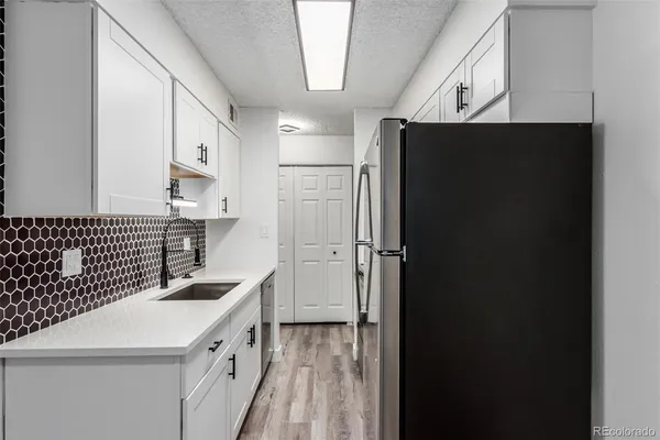 a kitchen with kitchen island cabinets and refrigerator