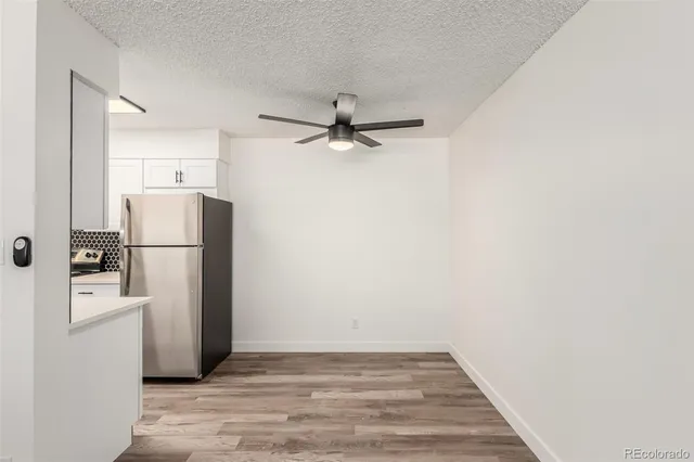 a view of a kitchen with a refrigerator a ceiling fan and a refrigerator
