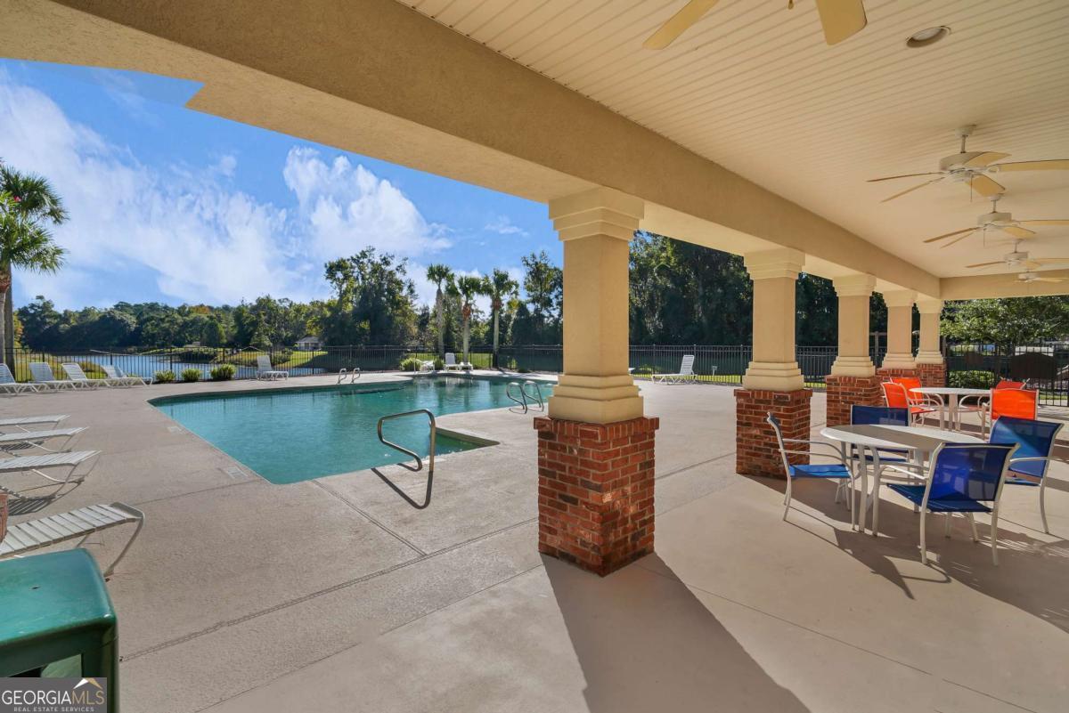 19 Clover Mill Point Brunswick, GA 31525 - Photo 7 of 9 a swimming pool with outdoor seating and lake view