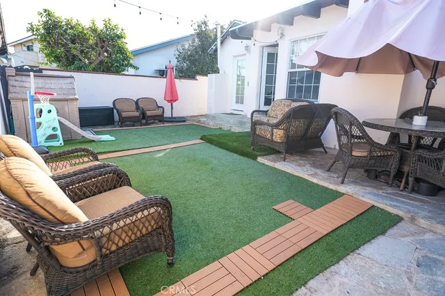 a view of backyard with seating area and trees