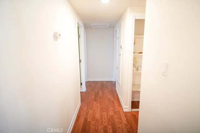 a view of a hallway with wooden floor