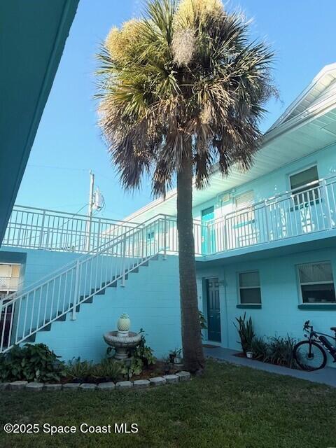 406 Tyler Avenue, Unit 19 Cape Canaveral, FL 32920 - Photo 13 of 13 a front view of a house with garden