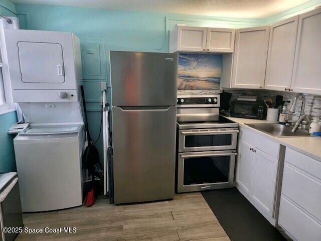 406 Tyler Avenue, Unit 19 Cape Canaveral, FL 32920 - Photo 6 of 13 a kitchen with a refrigerator sink and cabinets