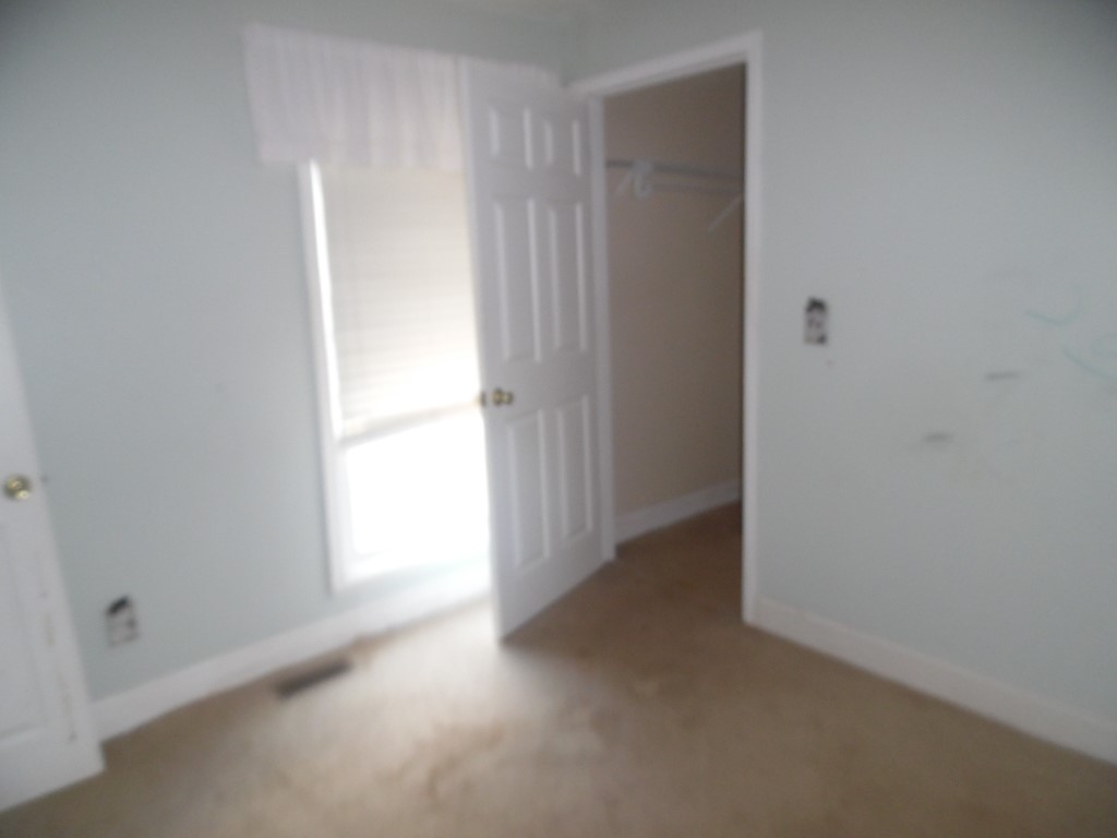 19 Haynes Street Due West, SC 29639 - Photo 7 of 8 A well-lit bedroom awaits personalization, featuring a window and convenient closet access.