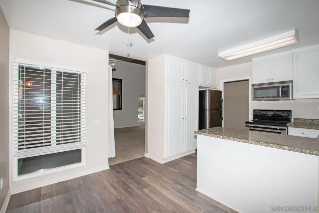 a kitchen with a refrigerator stove and microwave
