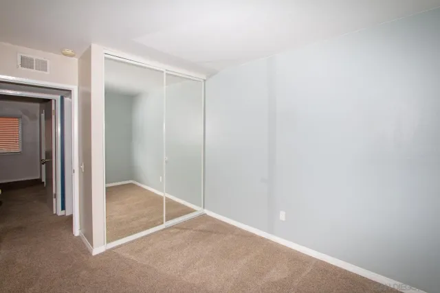 a bathroom with a granite countertop sink toilet mirror and shower