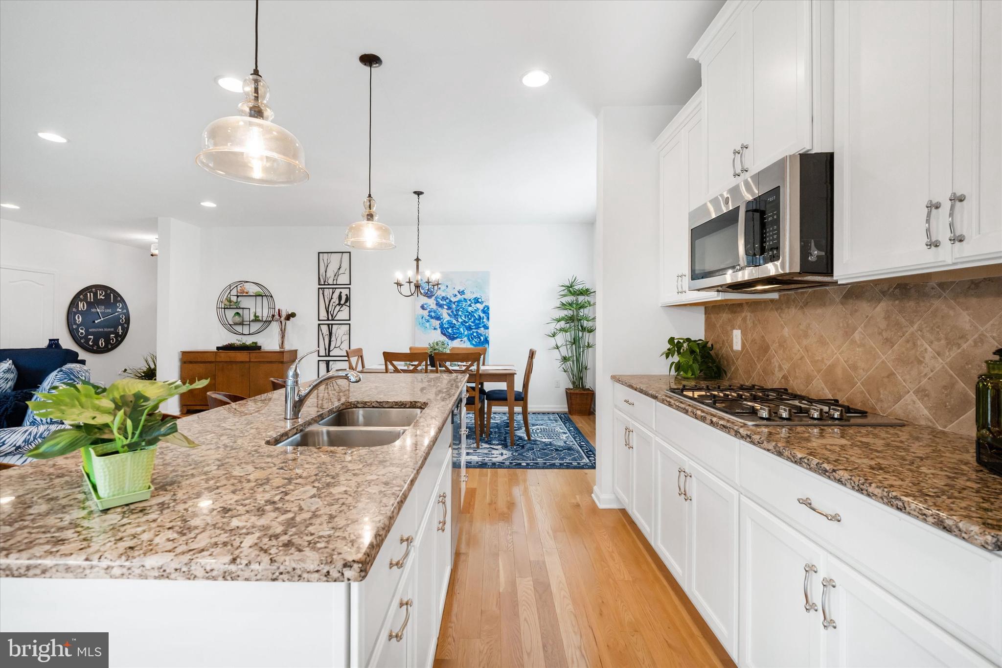 5338 Newman Lane Middletown, DE 19709 - Photo 27 of 61 a kitchen with stainless steel appliances granite countertop a stove a sink and a microwave