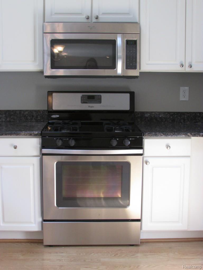 46 Eagle Ridge Road Lake Orion, MI 48360 - Photo 7 of 35 Brand new stainless steel appliances are included - gas range and built in microwave shown here