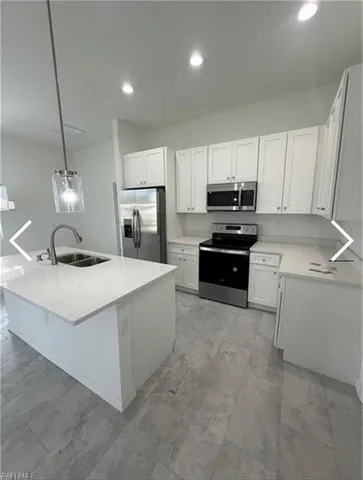 a kitchen with a sink a stove and oven