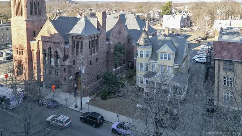 a aerial view of a house with a yard basket ball court and outdoor seating