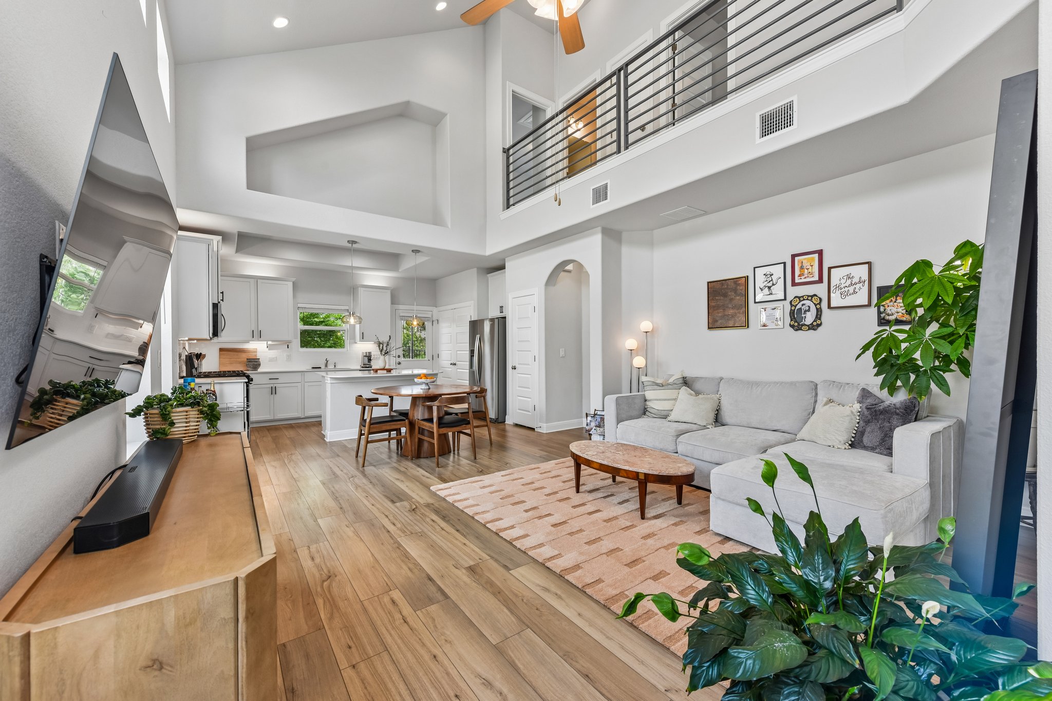 9901 Thane Way, Unit 91 Austin, TX 78748 - Photo 5 of 24 Stunning two-story living room filled with natural light, creating a bright and airy feel