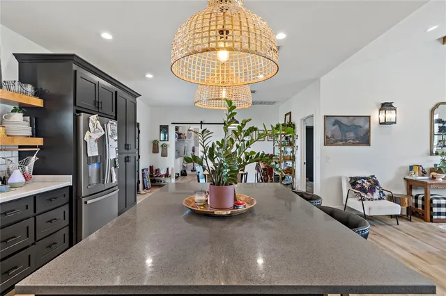 a kitchen with stainless steel appliances granite countertop a refrigerator and a sink